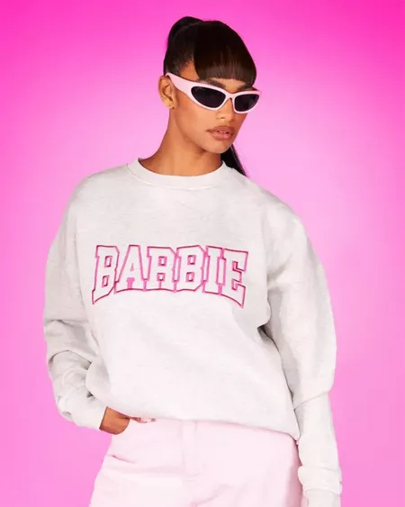 Model wears a Barbie x Boohoo sweatshirt