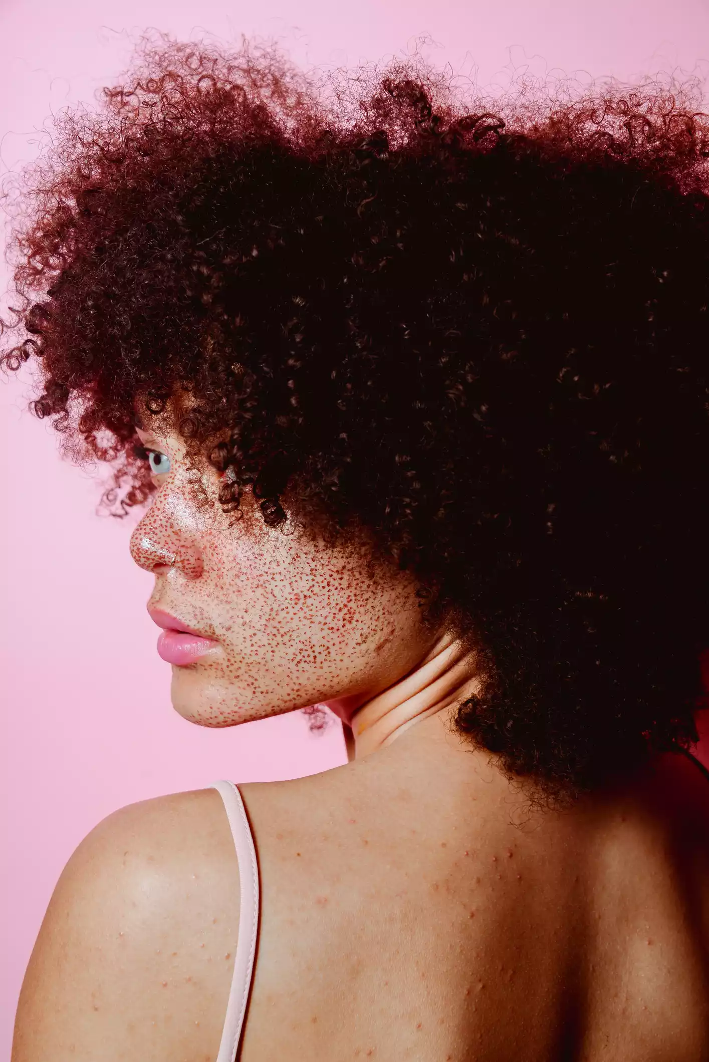 Profile of Young Womans Back with Natural Hair and Freckles
