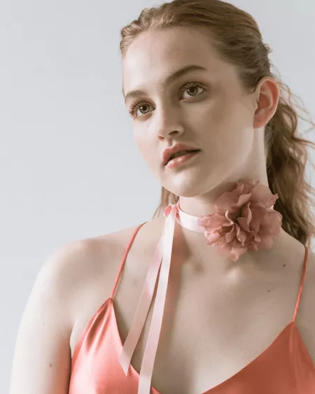 Model wearing a rose necklace