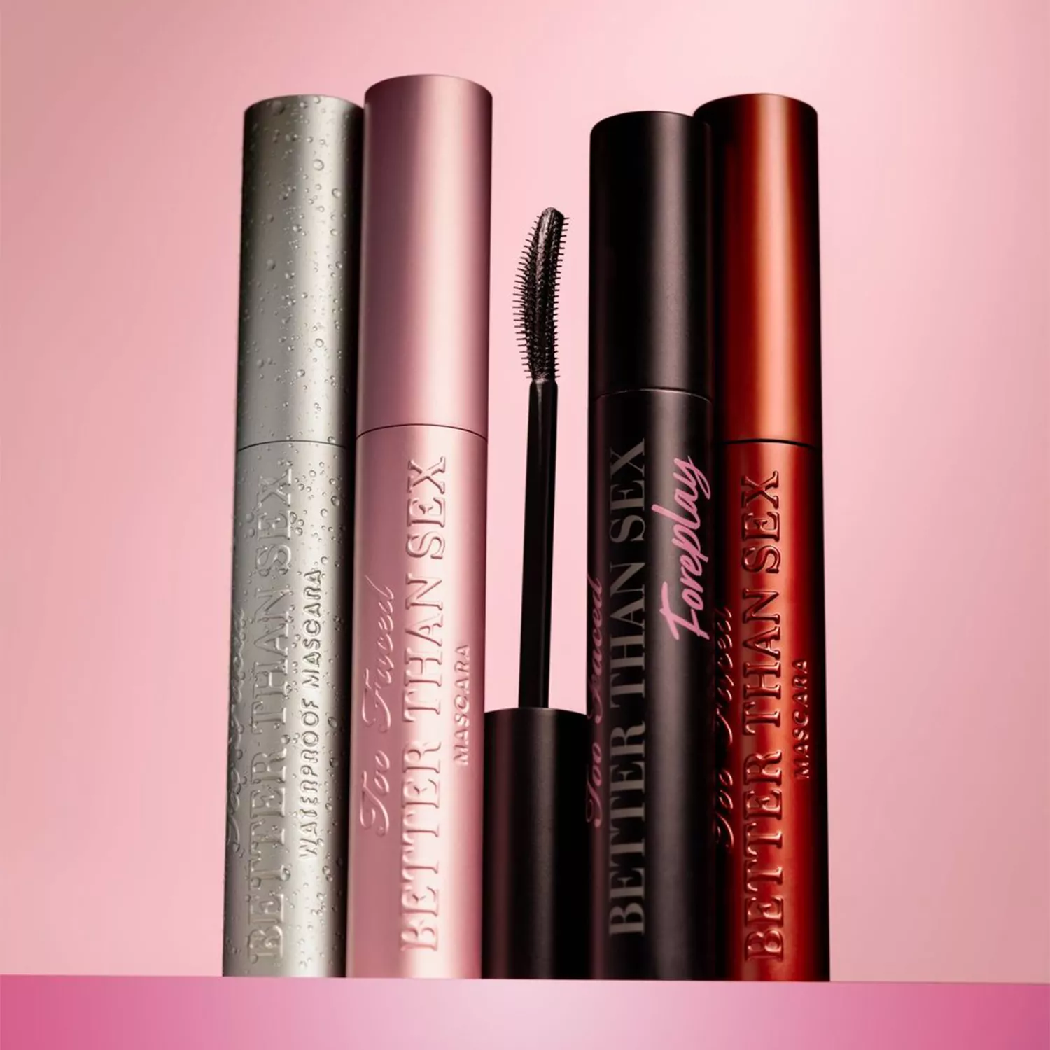 Too Faced Mascaras on a pink background